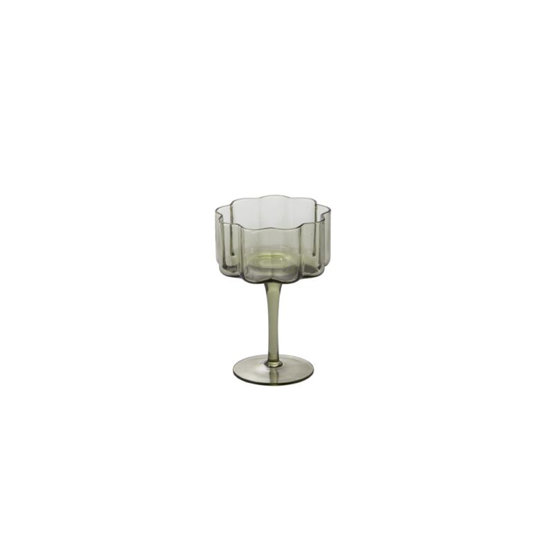 As decorative as it is functional, the Floret Coupe Glass is right at home styled on bar carts or open kitchen shelving. This trendy handmade solid glass drinkware elevates any cocktail party, event, or home bar with its smoky grey hue, scalloped rim, & vertical ridging. Food & dishwasher safe, this glass is even more beautiful arranged alongside the whole Floret glassware family.