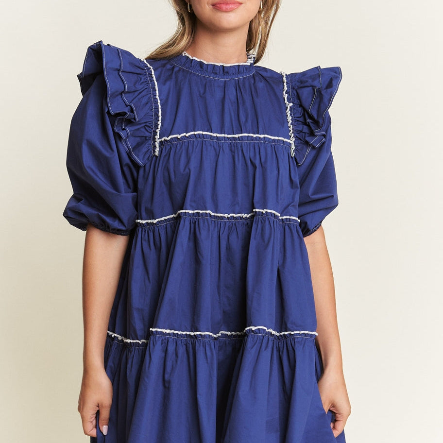 Rock the boat in this Navy Baby Doll Mini Dress with large sleeves, bold navy blue color, and eye-catching white line detailing. Perfect for a flirty and fun look, this mini dress is sure to make a statement. Let your playful side shine through with this quirky and stylish piece!