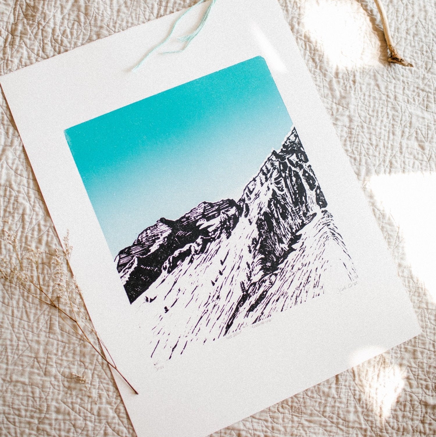 hand carved and pressed black and white 15x20 print of snowbird with a blue sky