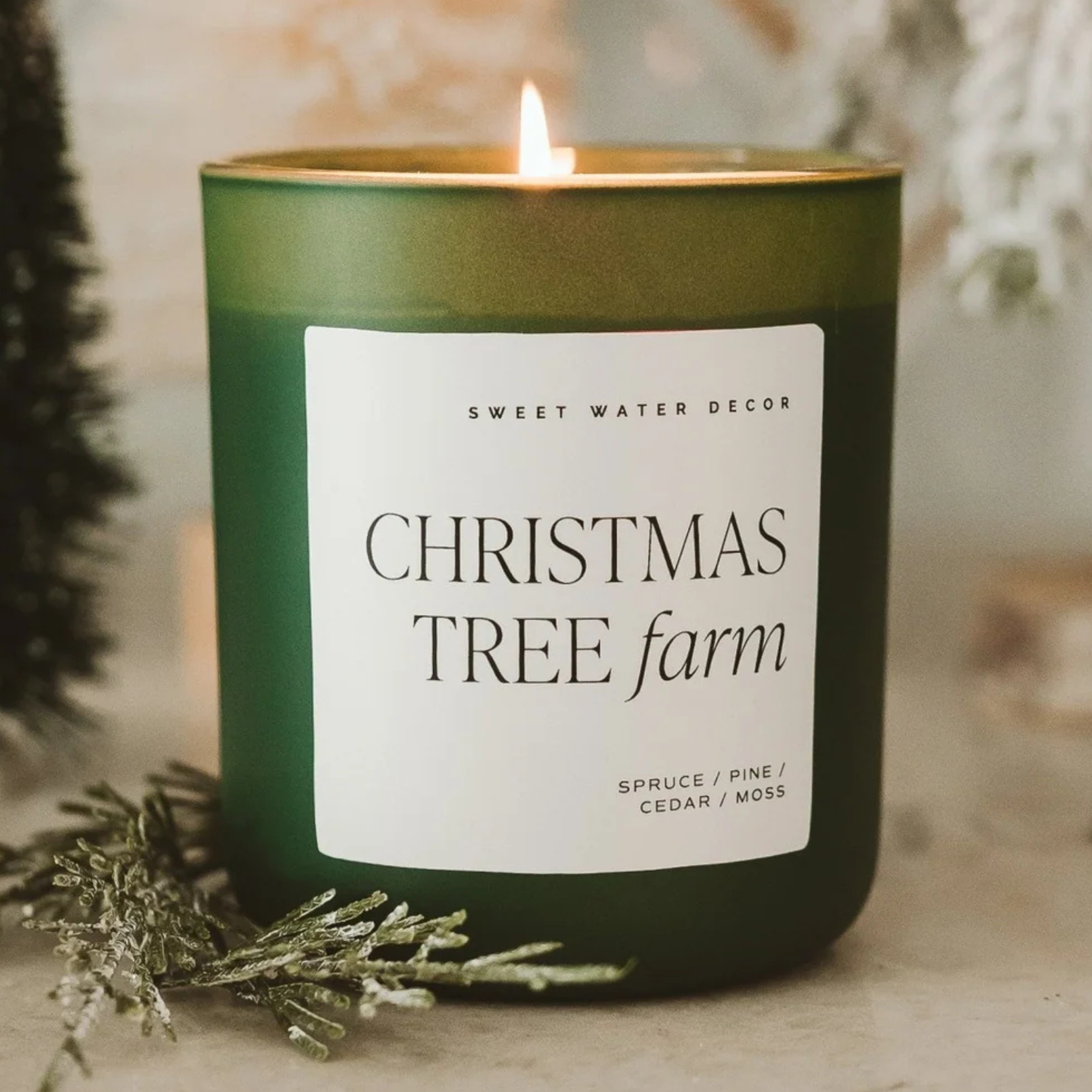Green candle labeled 'Christmas Tree Farm' with a blurred background