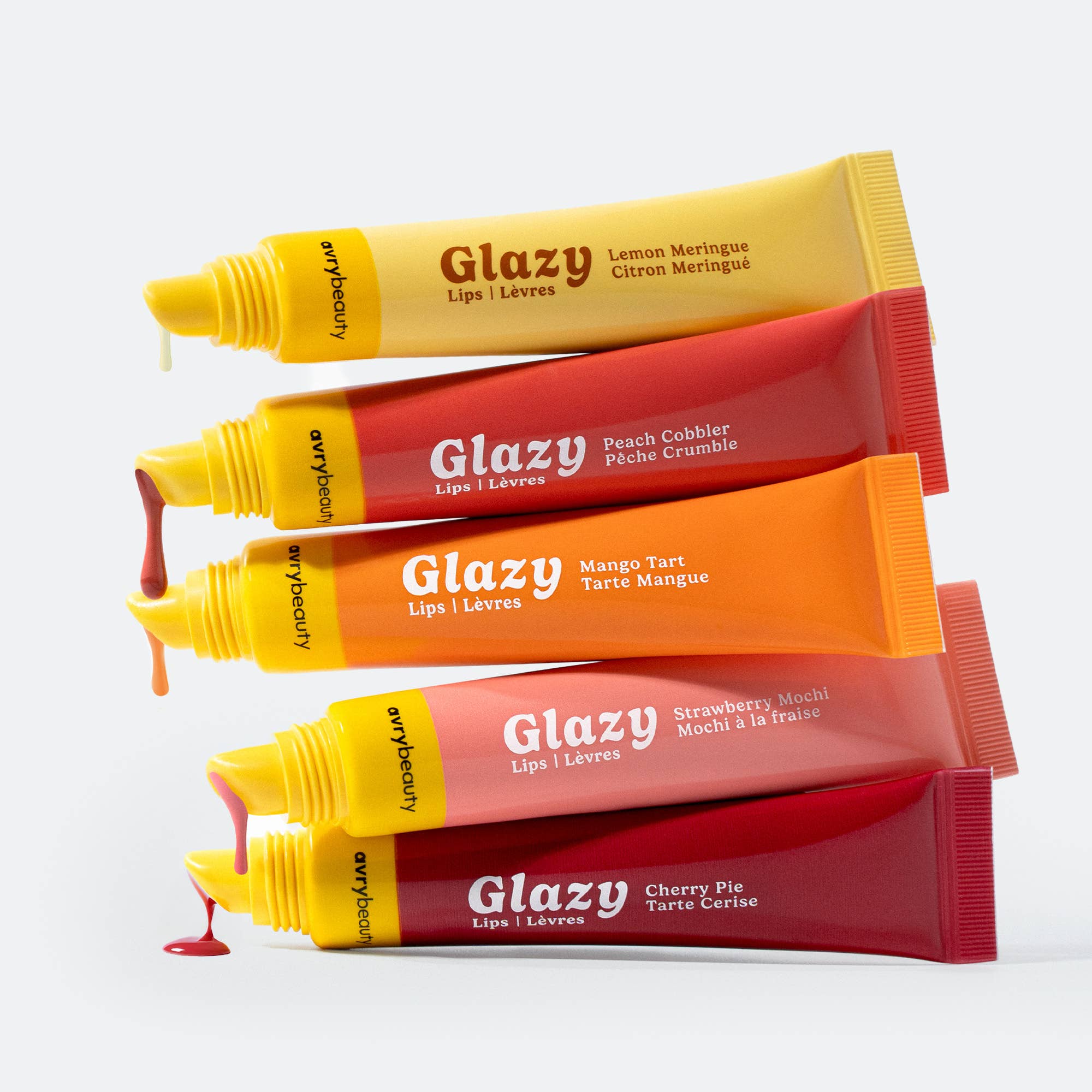Five Glazy lip balm tubes in different flavors on a white background
