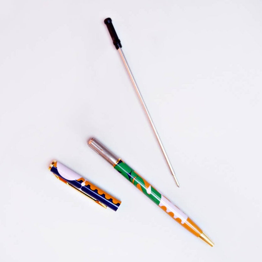 Make writing a little more fabulous with this printed metal pen with real gold plated trim. It has a fine ball point and black ink. And it's refillable! Refills sold separately.