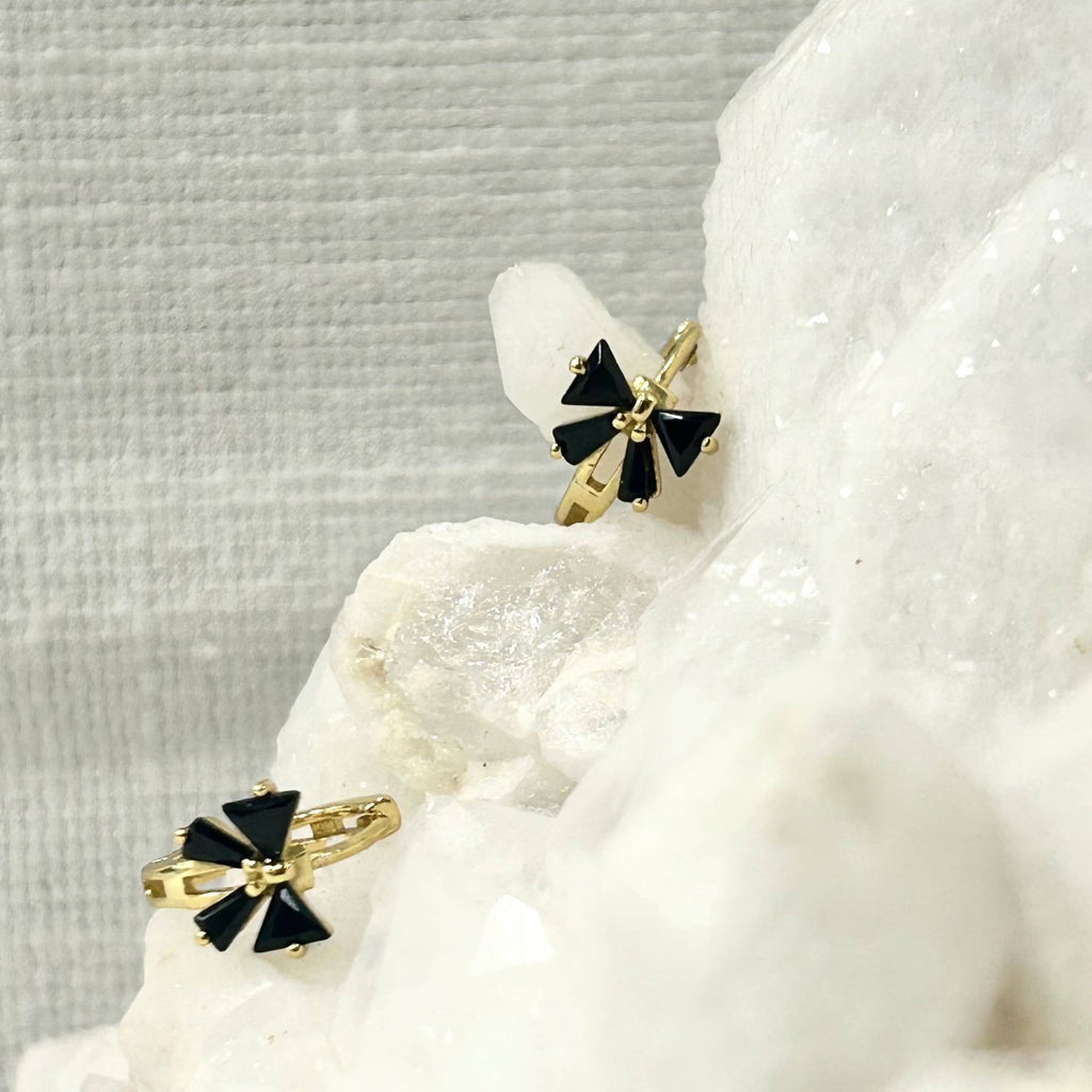 Add a touch of fun and classy to your every day by sporting these little bow huggie hoops! Bows aren't just functional and pretty knots for sealing gifts, they can represent strength, union, and beauty.

•&nbsp;925 sterling silver with gold plating

• Extra layer of tarnish resistance

• Black Cubic Zirconia stones

• Manufactured for our curated collection.