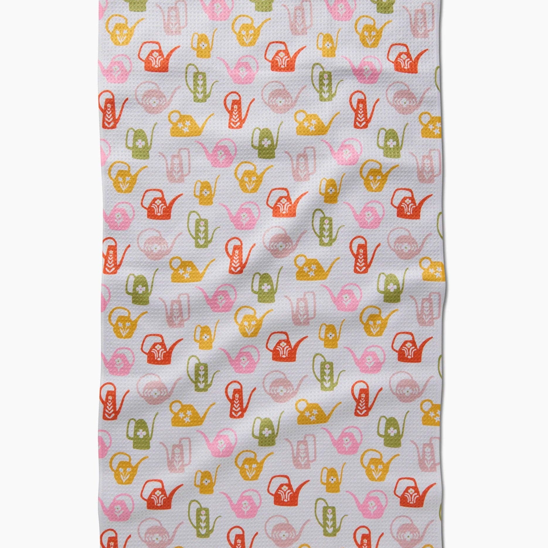 Fabric with colorful watering can pattern on a white background