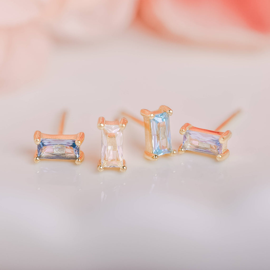  Birthstone Ombre Baguette Stud Earring Set, a collection of four stunning earrings crafted in 18k gold plated with an anti-tarnish coating. This set of stud earrings showcases the ombre effect, seamlessly blending hues from light to dark, creating a captivating visual representation of your birthstone's color spectrum. 