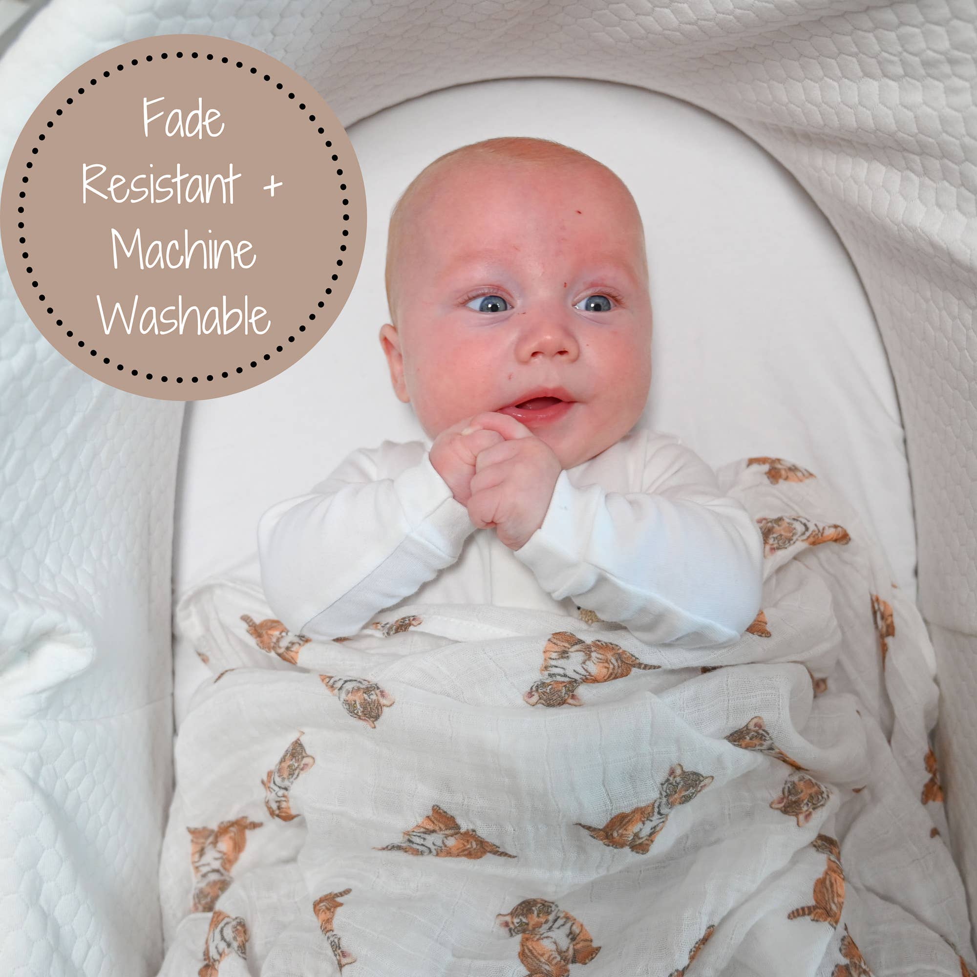 Baby wrapped in a floral-patterned swaddle with text 'Fade Resistant + Machine Washable' on a white background.