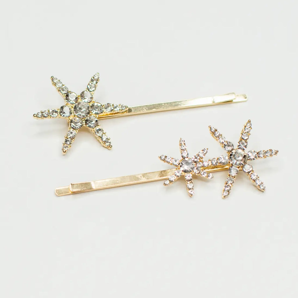 Add a touch of sparkle to your style with our Twinkle Bobbie set! Each set includes two gold bobby pins adorned with glittering gem stars that provide the perfect amount of shine. With these golden pins, you'll be able to light up the room and shine like a star! These pins are perfect for adding extra glam to any hairstyle, so you can look and feel like a true star.