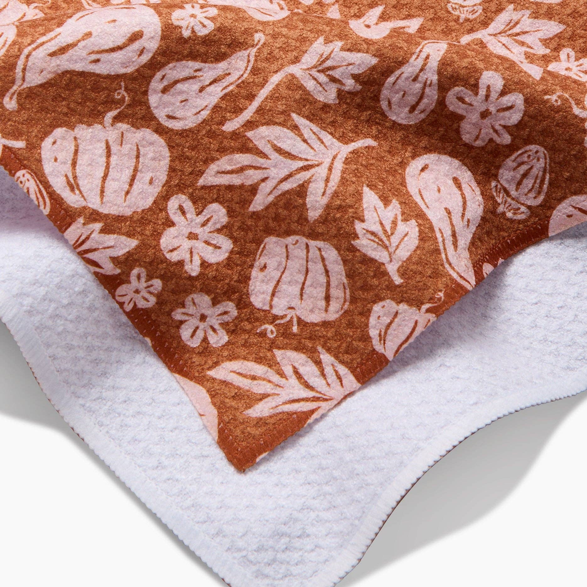 Fabric with pumpkin and leaf pattern on a brown background