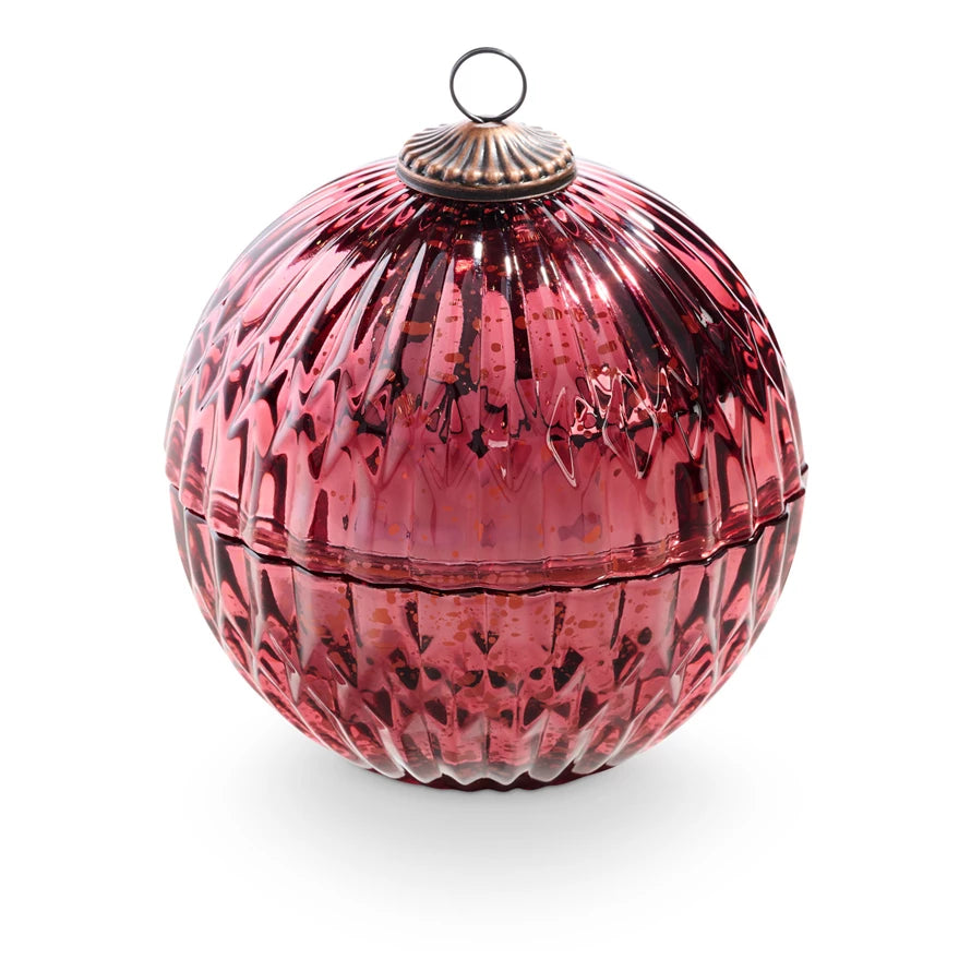 Red glass ornament with textured surface on a white background