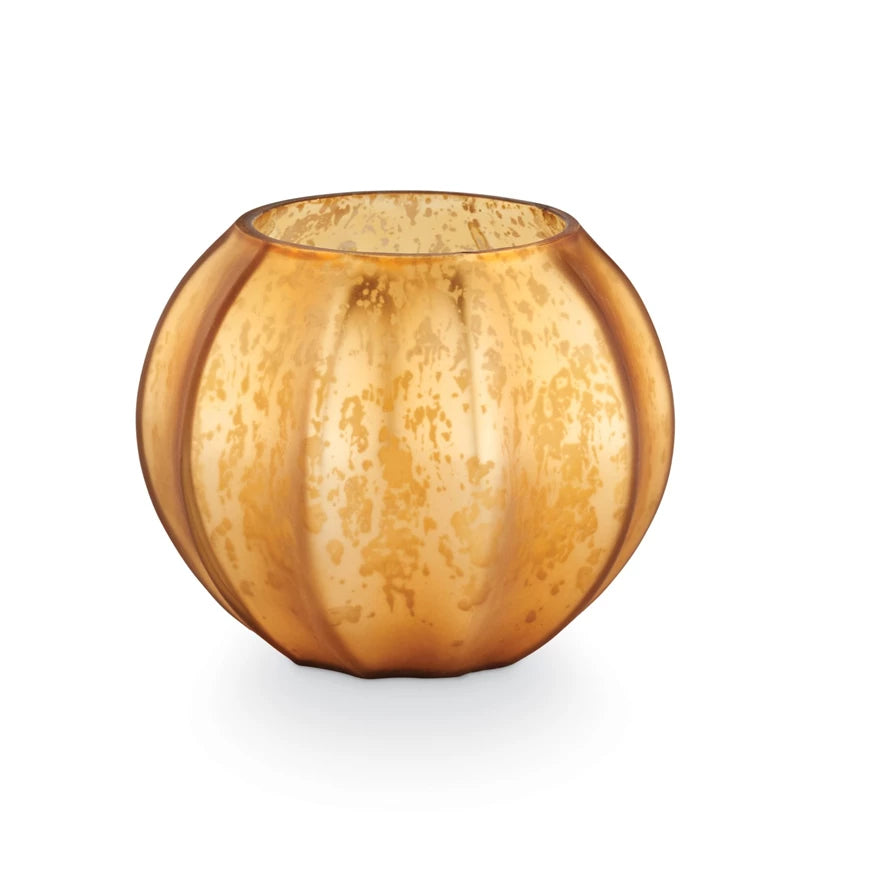 Round amber glass candle holder on a white background