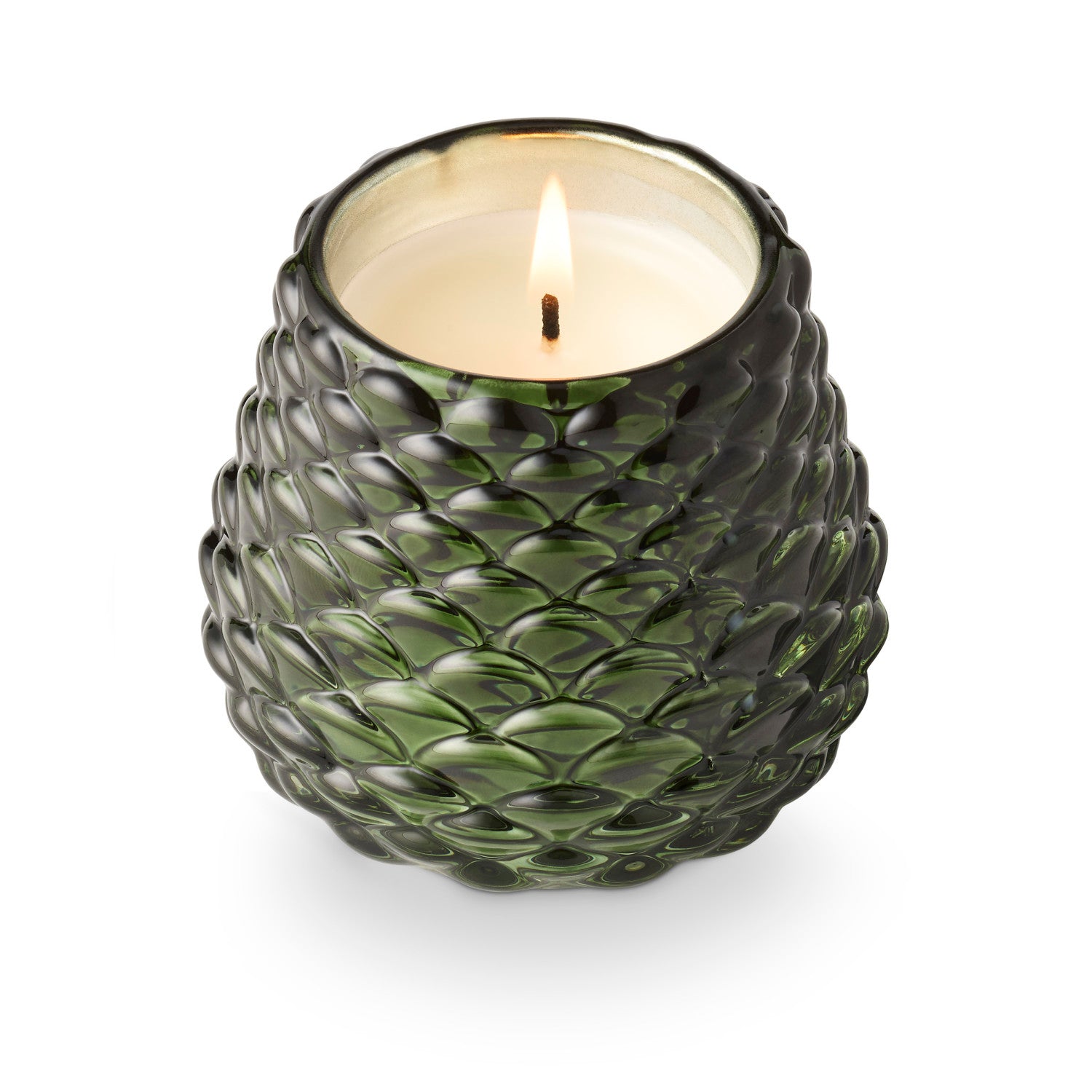 Green textured candle holder with a lit candle on a white background