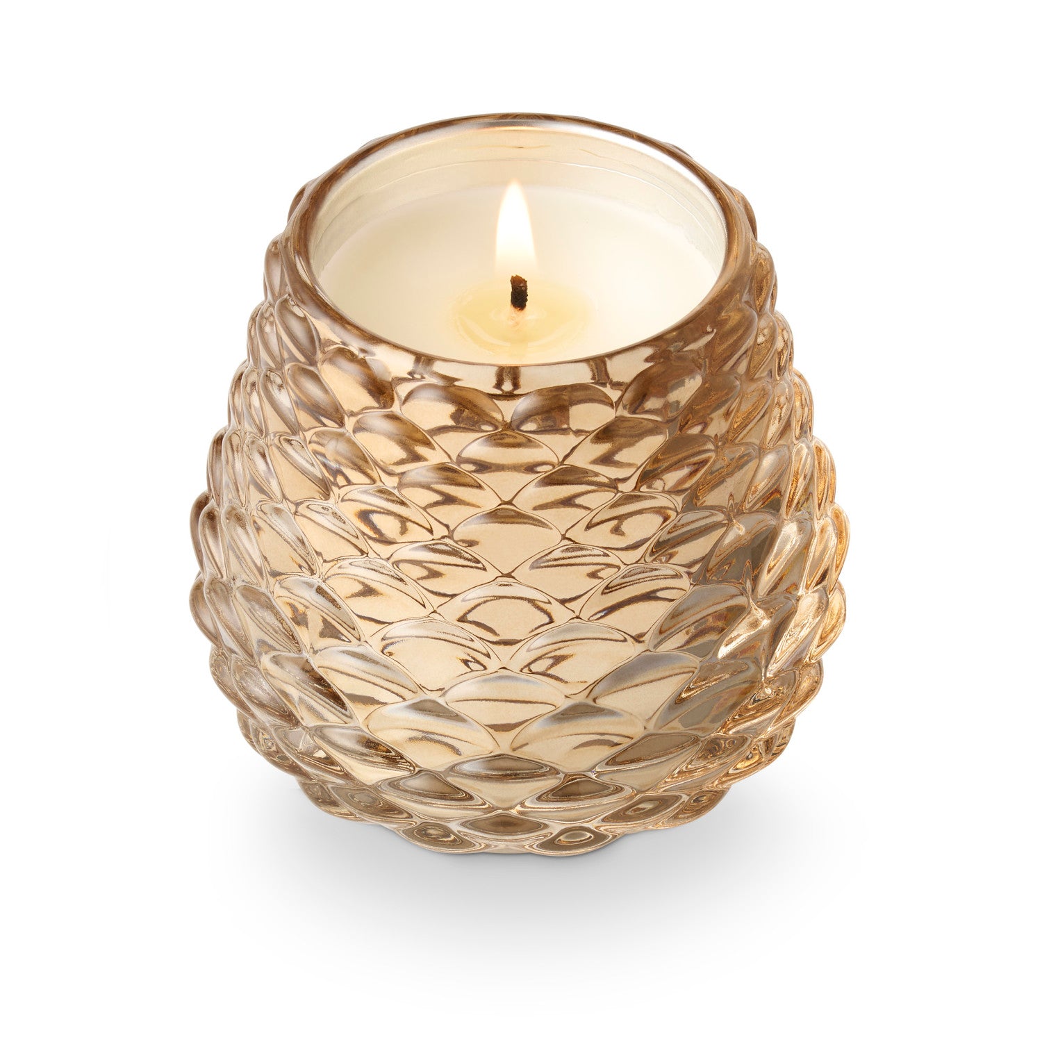 Decorative glass candle holder with a lit candle on a white background