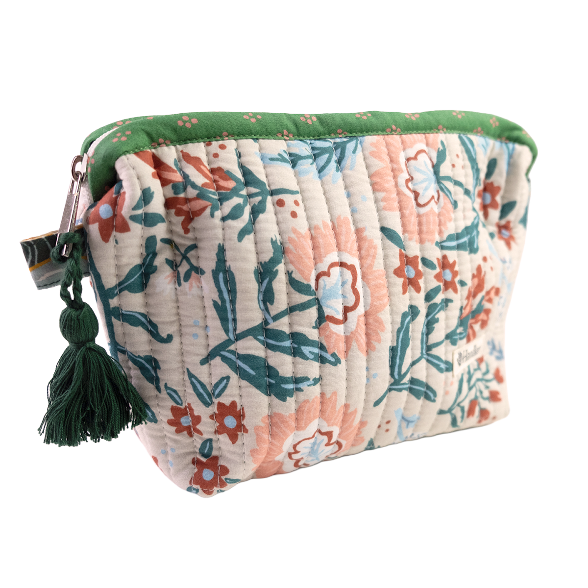 Floral patterned pouch with green tassel on a white background