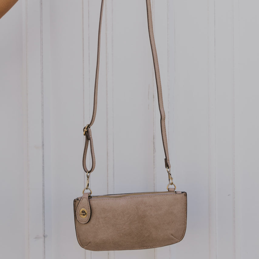 The Uptown Messenger Purse is perfection in a handbag! This versatile piece can be used as an adjustable cross-body bag, wristlet, or a simple wallet, making it the perfect finishing touch to any night out. A zippered top and rotating clasp closure are timeless elements that will make this the most functional purse you'll ever own!