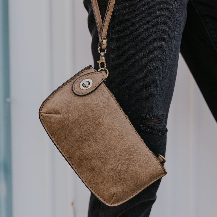 The Uptown Messenger Purse is perfection in a handbag! This versatile piece can be used as an adjustable cross-body bag, wristlet, or a simple wallet, making it the perfect finishing touch to any night out. A zippered top and rotating clasp closure are timeless elements that will make this the most functional purse you'll ever own!