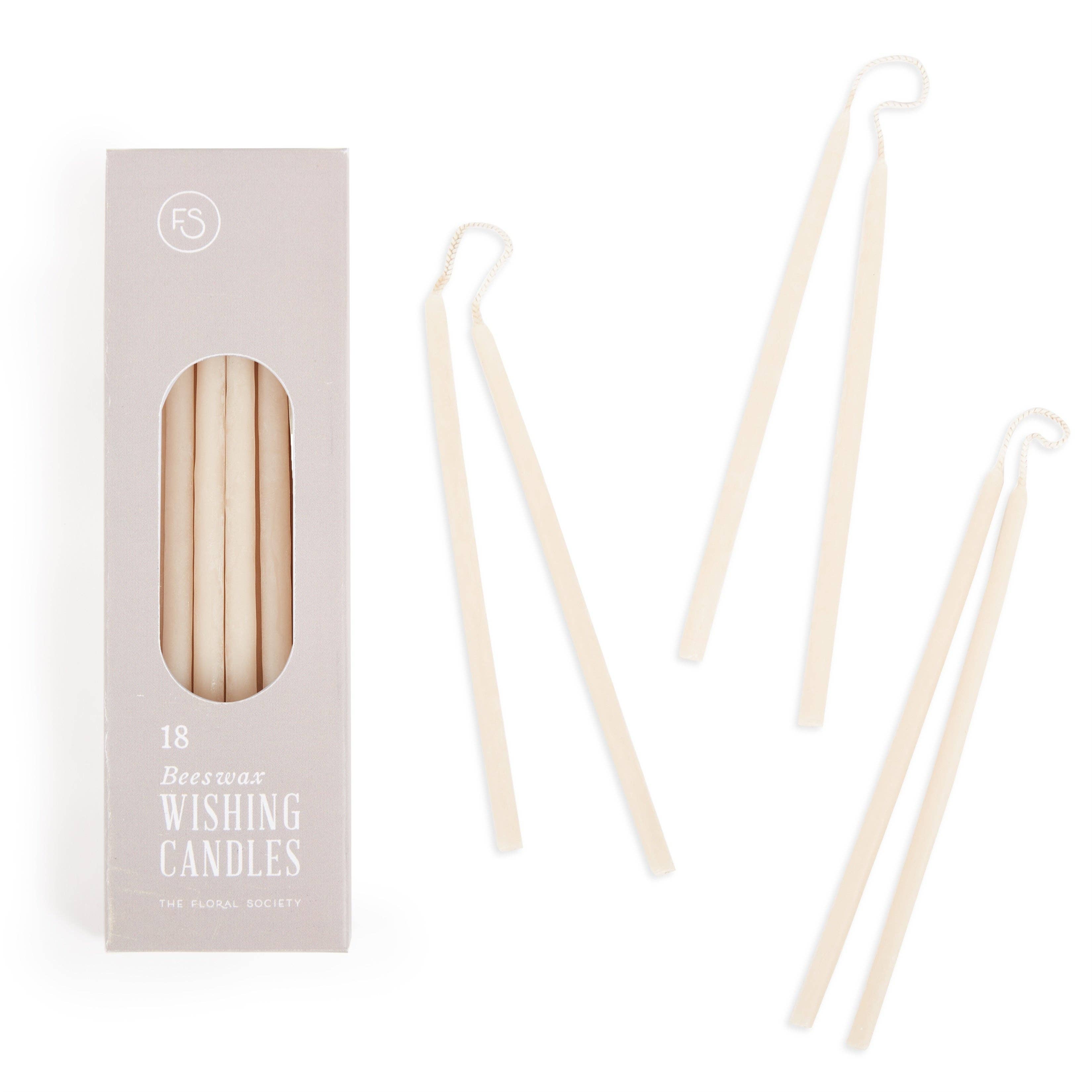 Beeswax wishing candles with packaging on a white background. salt color