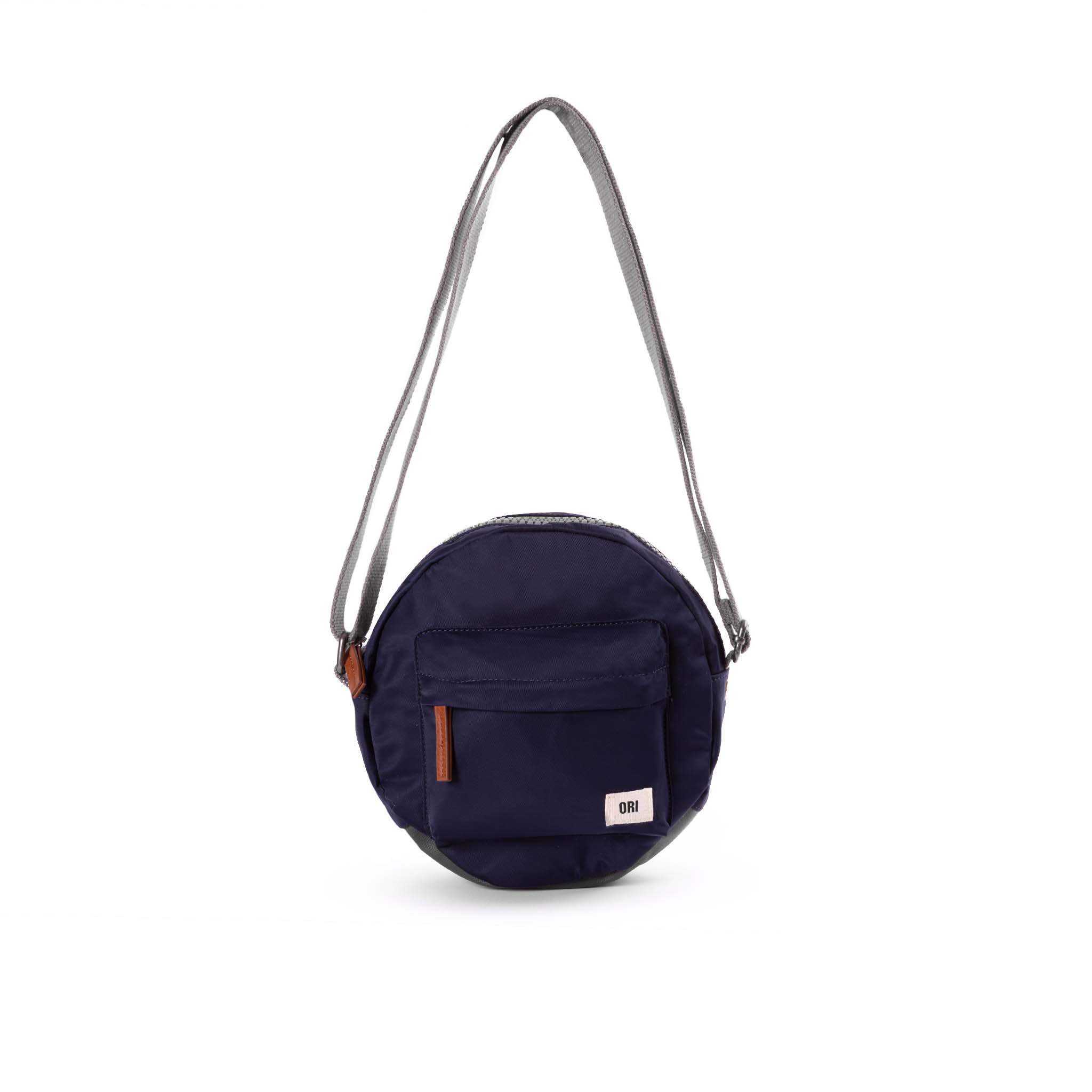 Over the shoulder and crosstown, our Paddington Crossbody is the perfect round bag to sling across your body and take on your day. Midnight&nbsp; COLOR

The Paddington bag has three pockets and sections to keep everything organized, safe and secure, all in weather-resistant, recycled material.

The size is the perfect accessory to store all your daily necessities - mobile, wallet, keys, and more! Our Paddington Crossbody is the only, stylish round bag out there.