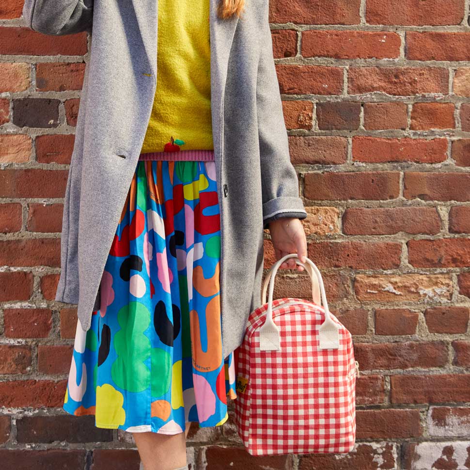 Certified organic cotton. Preshrunk and fully machine washable. Cotton canvas carry handles. Zipper closure. Rinse-able, tested food-safe lining. Interior pocket (for a water bottle or ice pack). Durable and roomy. Lunch bag is lined but not insulated. Water-resistant lining works well with an ice pack, if desired. Gingham Red pattern.