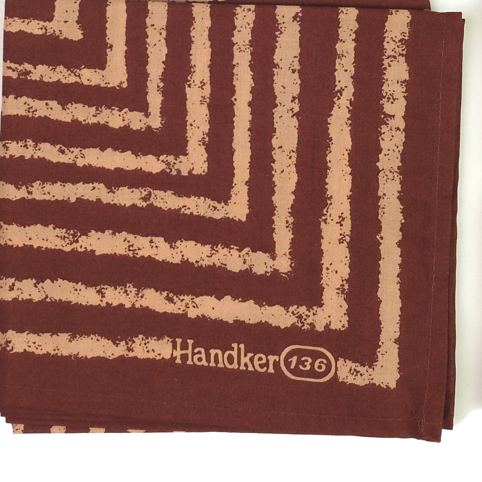 Brown handkerchief with beige zigzag pattern and 'Handker 136' branding.