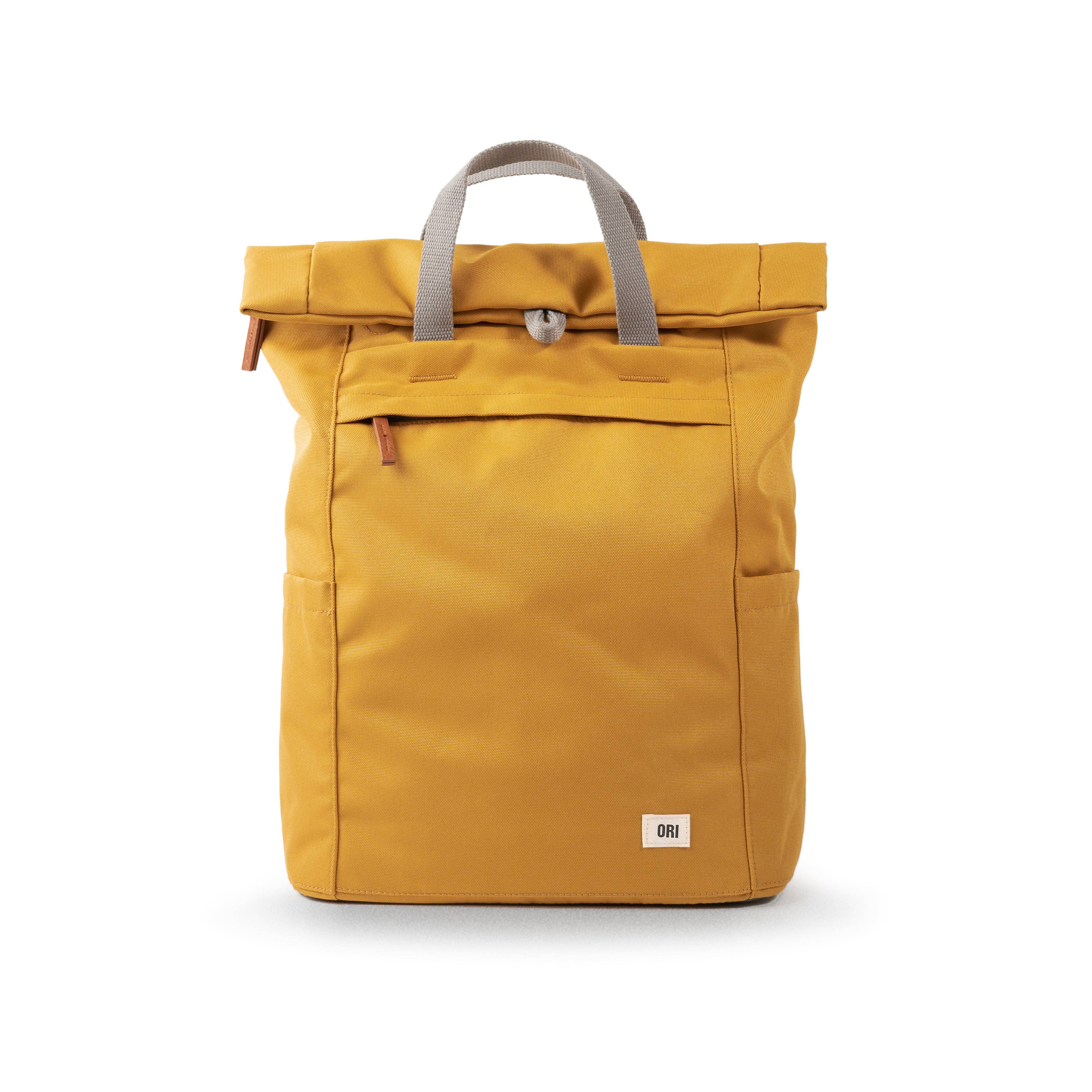 Rock the outdoor look with our minimalist-design, roll-top backpack with a large front pocket with a chunky zip. Flax

This weather-resistant bag has extra storage space, a padded laptop or tablet sleeve and loads of pockets. Made using recycled Canvas made from plastic waste and coated to make it water-resistant, our canvas material is weather-resistant, lightweight, and as durable as all our ORI London bags.