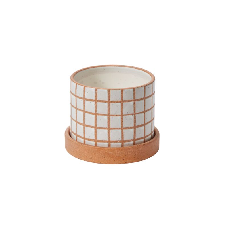 With its contrasting colors & geometric grid pattern, the small Gridline Pot lifts up the room with color & texture. This pot with a drainage hole features a textural grid design etched on a brown clay base. The white glazed squares have a smooth feel, while the linework & saucer have a sandy texture. This fun indoor plant pot makes a happy addition to a modern plant shop & home decor.