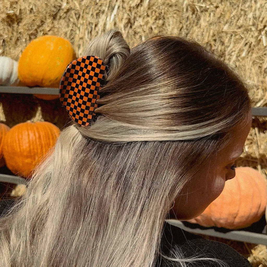 Take your hair game to the next level with this Orange Gingham Hair Claw! Whether you’re looking for an autumnal accessory, or just want to add a checkered pop of color, this rounded claw is the perfect way to keep your hairstyle in place with a side of autumn flair!