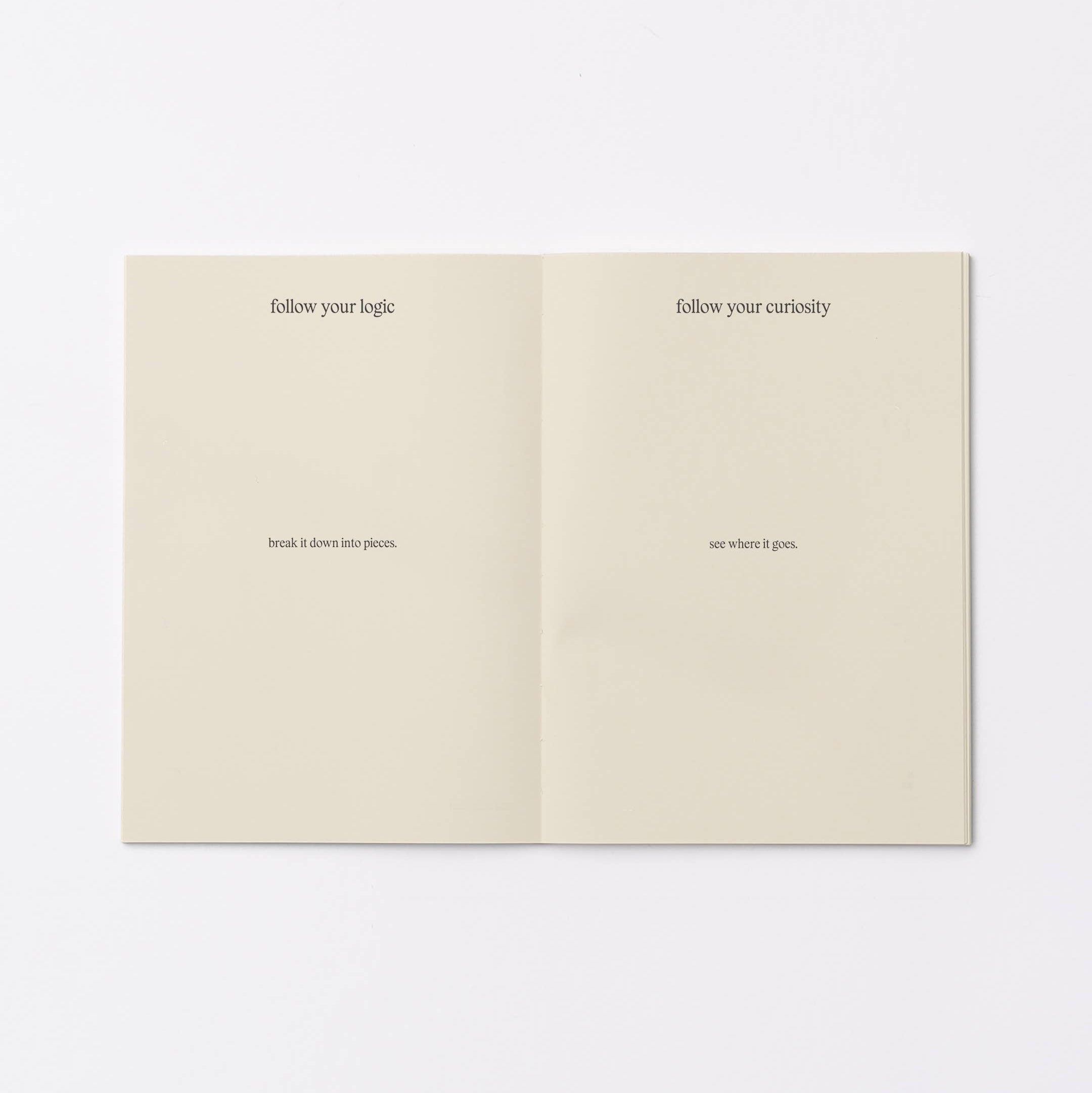 An open booklet or notebook spread on a plain white background, showing two cream-colored pages with small black printed text.