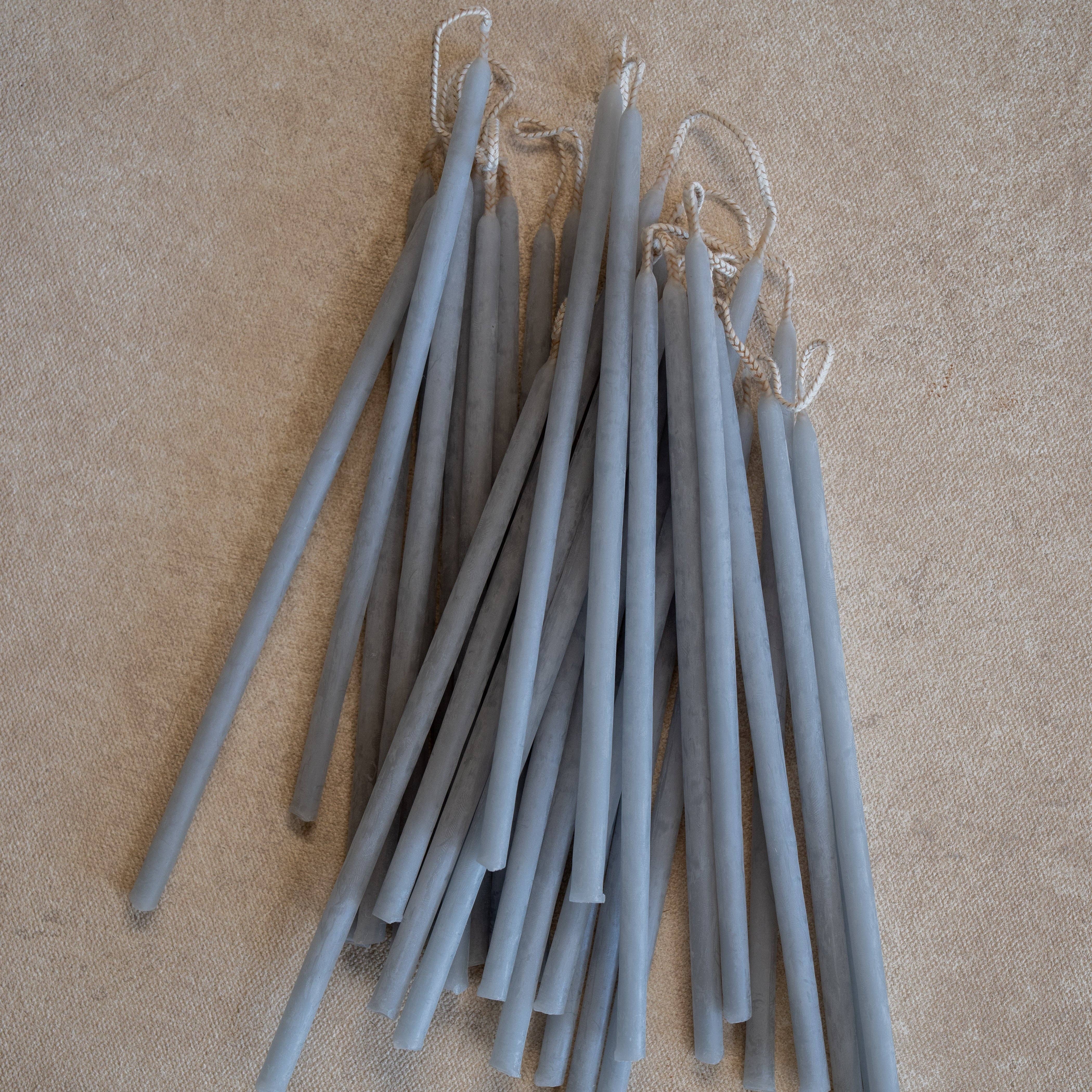blue mist candles with string on a beige background