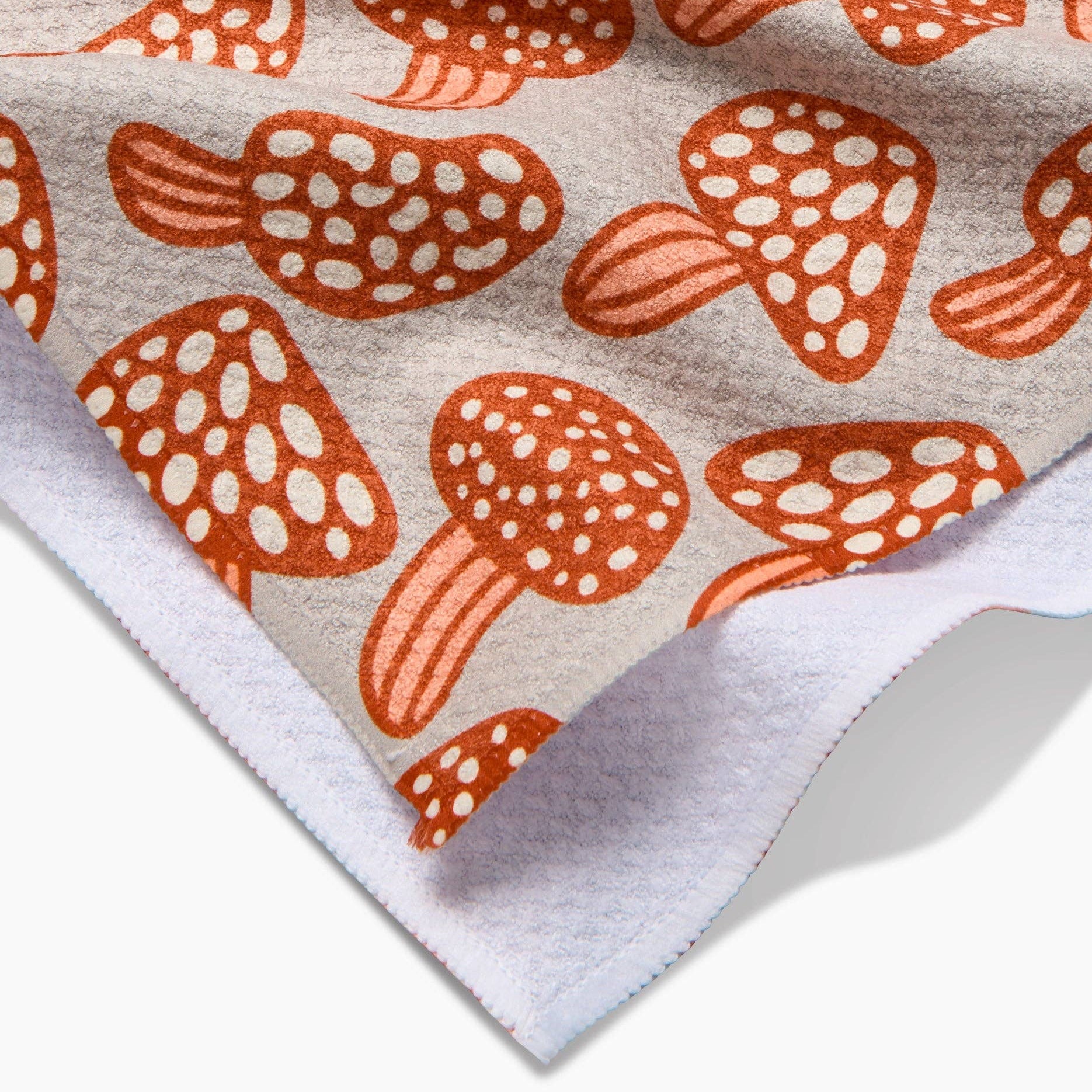 Fabric with orange mushroom pattern on a beige background