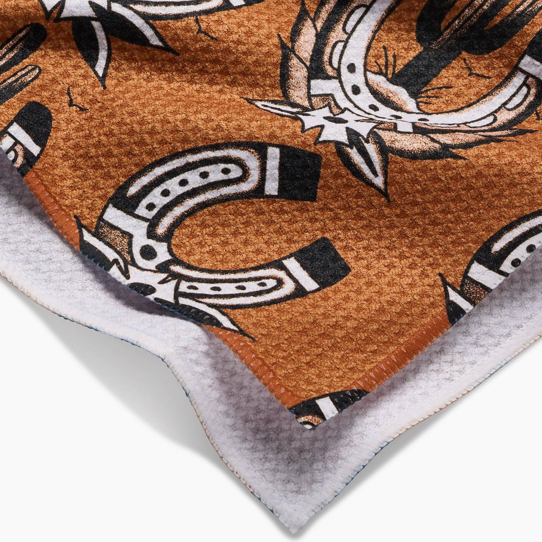 Fabric with horseshoe pattern on a brown background
