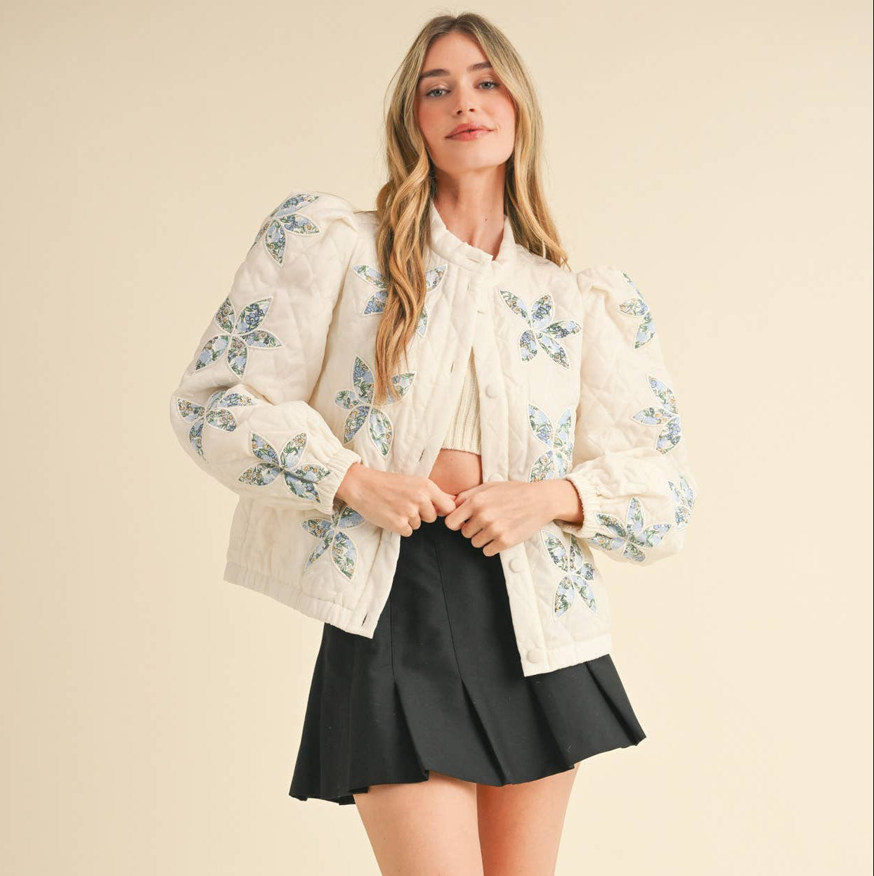 Be a style icon in this quilted floral jacket! Sturdy quilted puffer shapes this chic jacket that features embroidered floral patchwork throughout. It has a button down closure, long sleeves, and gathered puff at the shoulders. Elastic cuffs, hem, and side pockets complete the look.