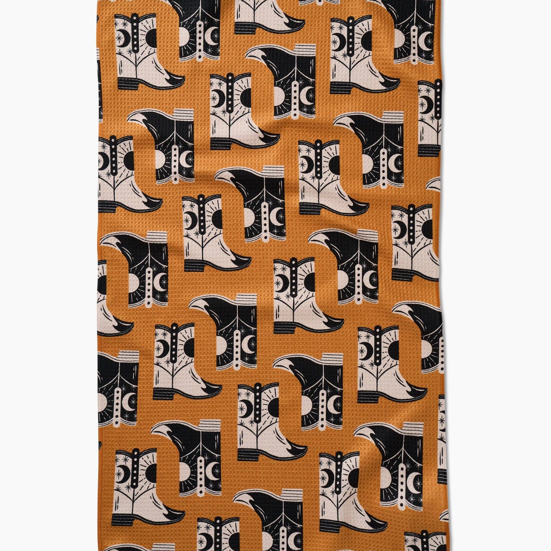 Patterned fabric with black and white cowboy boots on a brown background
