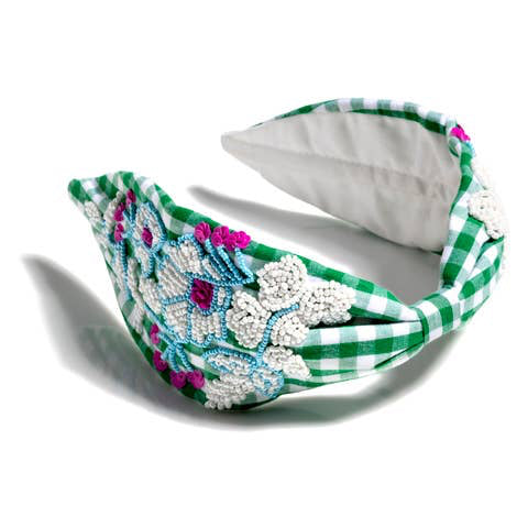 Elevate your look with our Embellished Check Wide Headband, crafted from quality polyester and handmade in India. This traditional gingham check headband features delicate hand beading details for a touch of elegance. Choose between two beautiful color options: green or pink. A comfortable and stylish accessory to complete any outfit.