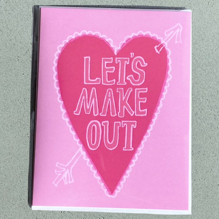 pink card with a hot pink heart with and arrow through it reading "Let's Make Out"