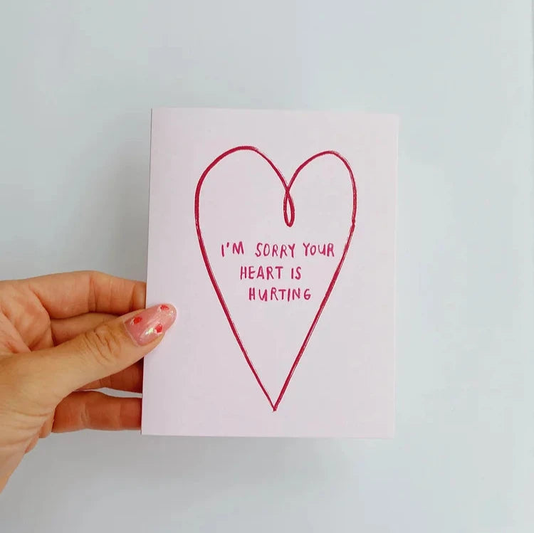 light pink card with a red heart outline reading "I'm sorry your heart is hurting"
