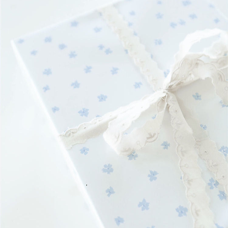white wrapping paper with delicate blue/lavender flowers