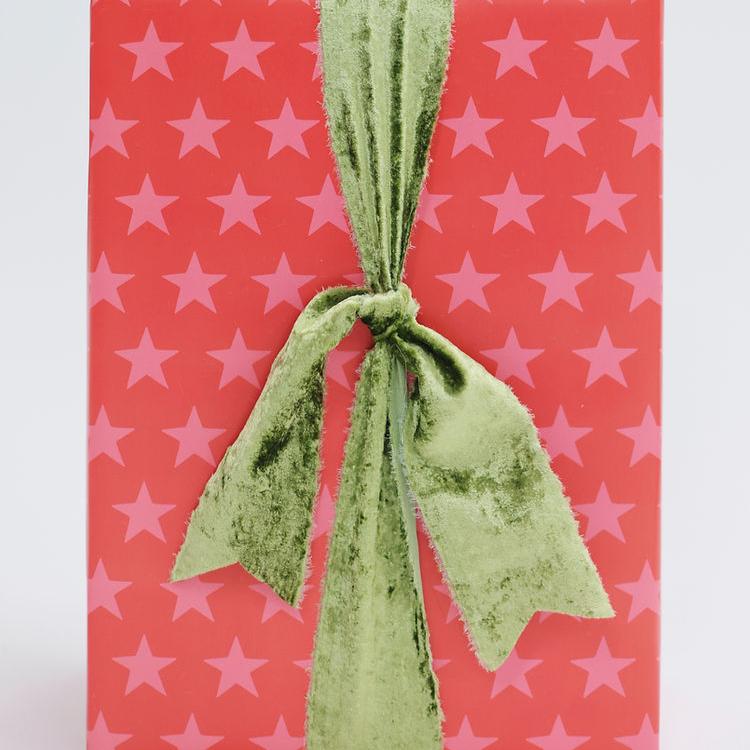 bright red wrapping paper covered with pink stars