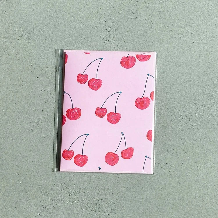 pink card with red cherries
