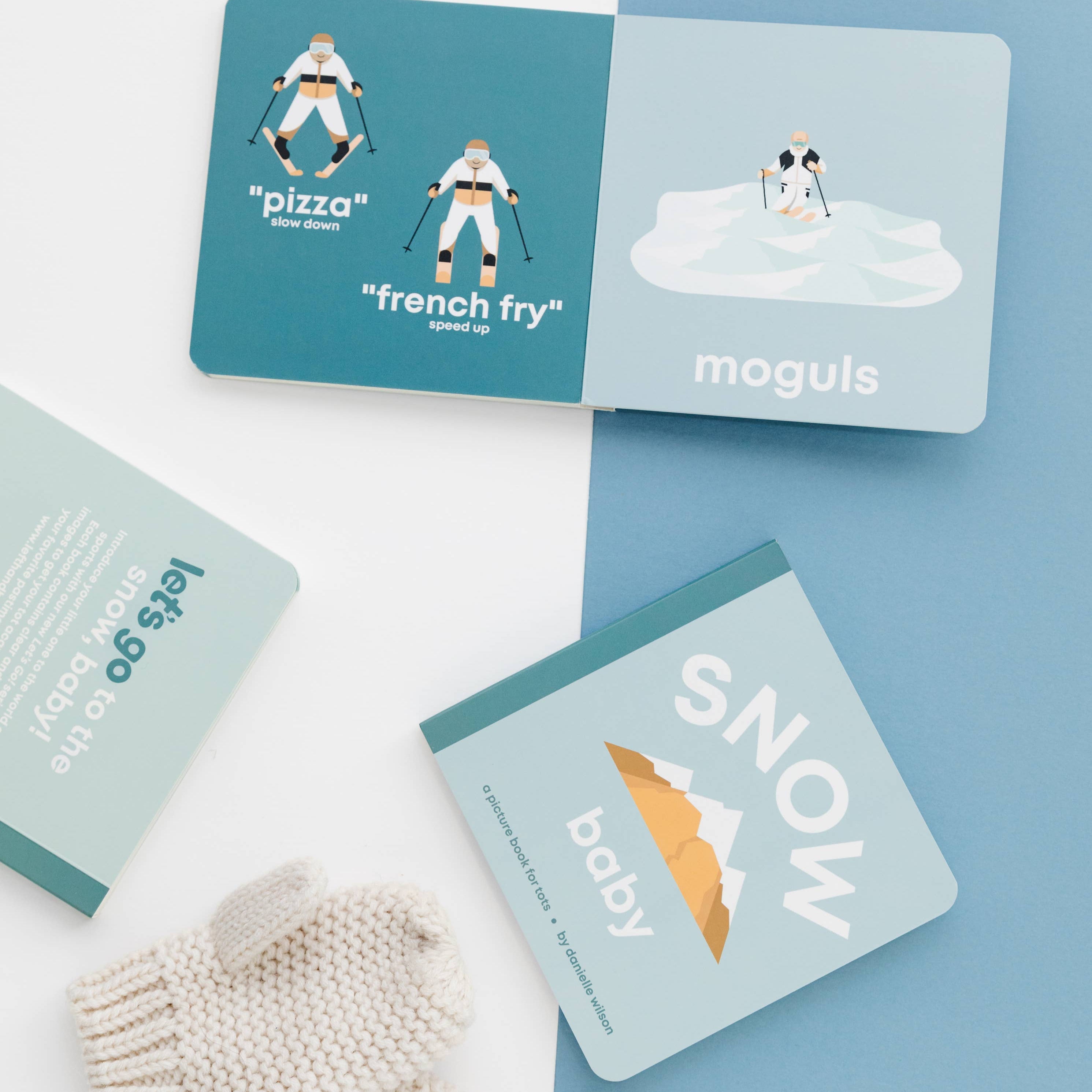 Set of snow-themed cards with illustrations and text on a blue and white background, featuring a pair of knit mittens.