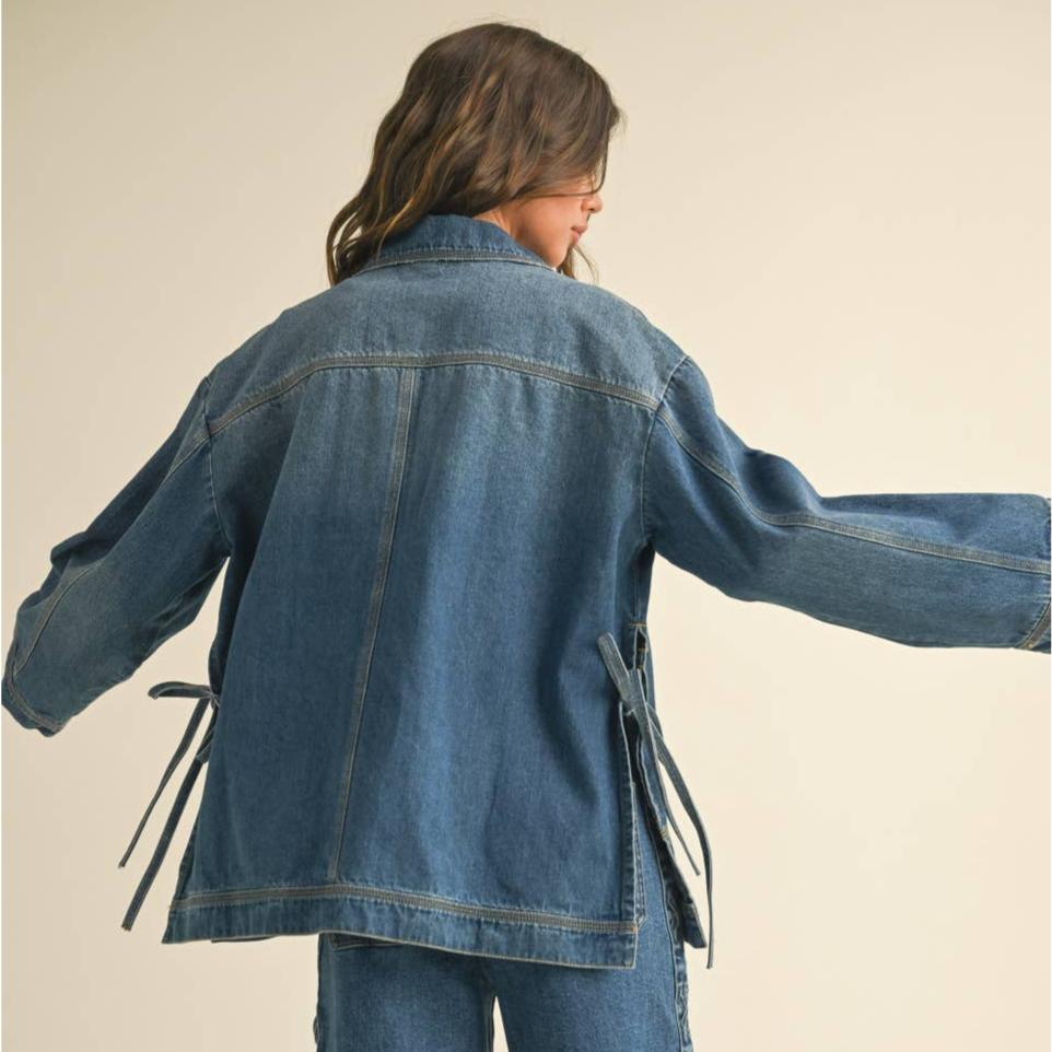 Get ready to tie up your style game with our Tied On the Side Denim Jacket! With its unique design, this jacket adds a touch of playful charm to any outfit. Made with high-quality denim, it's both stylish and durable. Say goodbye to boring jackets and hello to a fun and fresh look!