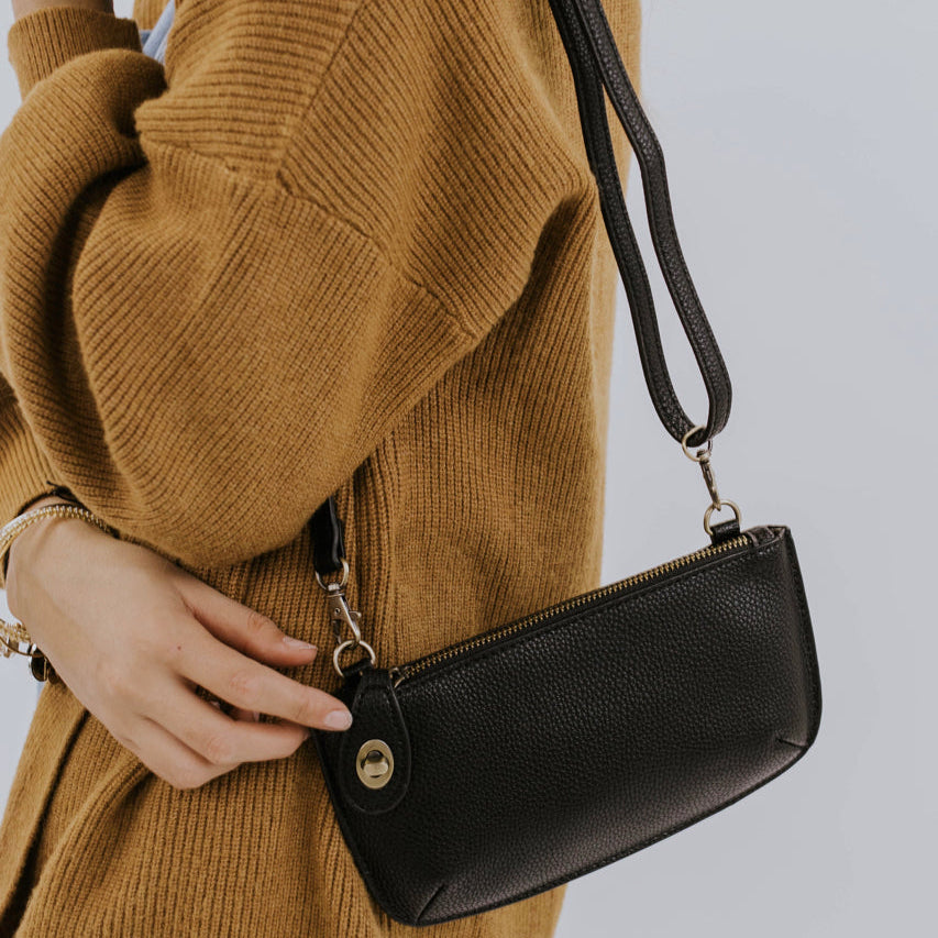 The Uptown Messenger Purse is perfection in a handbag! This versatile piece can be used as an adjustable cross-body bag, wristlet, or a simple wallet, making it the perfect finishing touch to any night out. A zippered top and rotating clasp closure are timeless elements that will make this the most functional purse you'll ever own!
