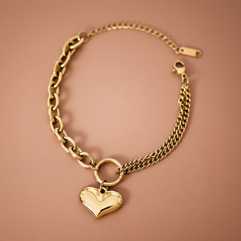 Elevate your everyday style with this 18K gold plated stainless steel chain bracelet, featuring a chunky heart charm. Crafted from hypoallergenic materials, it's perfect for sensitive skin and designed to withstand daily wear with its waterproof and tarnish-resistant properties. The lustrous gold finish maintains its brilliance when kept away from lotions, perfumes, and harsh chemicals. A timeless accessory that combines durability with elegant sophistication.