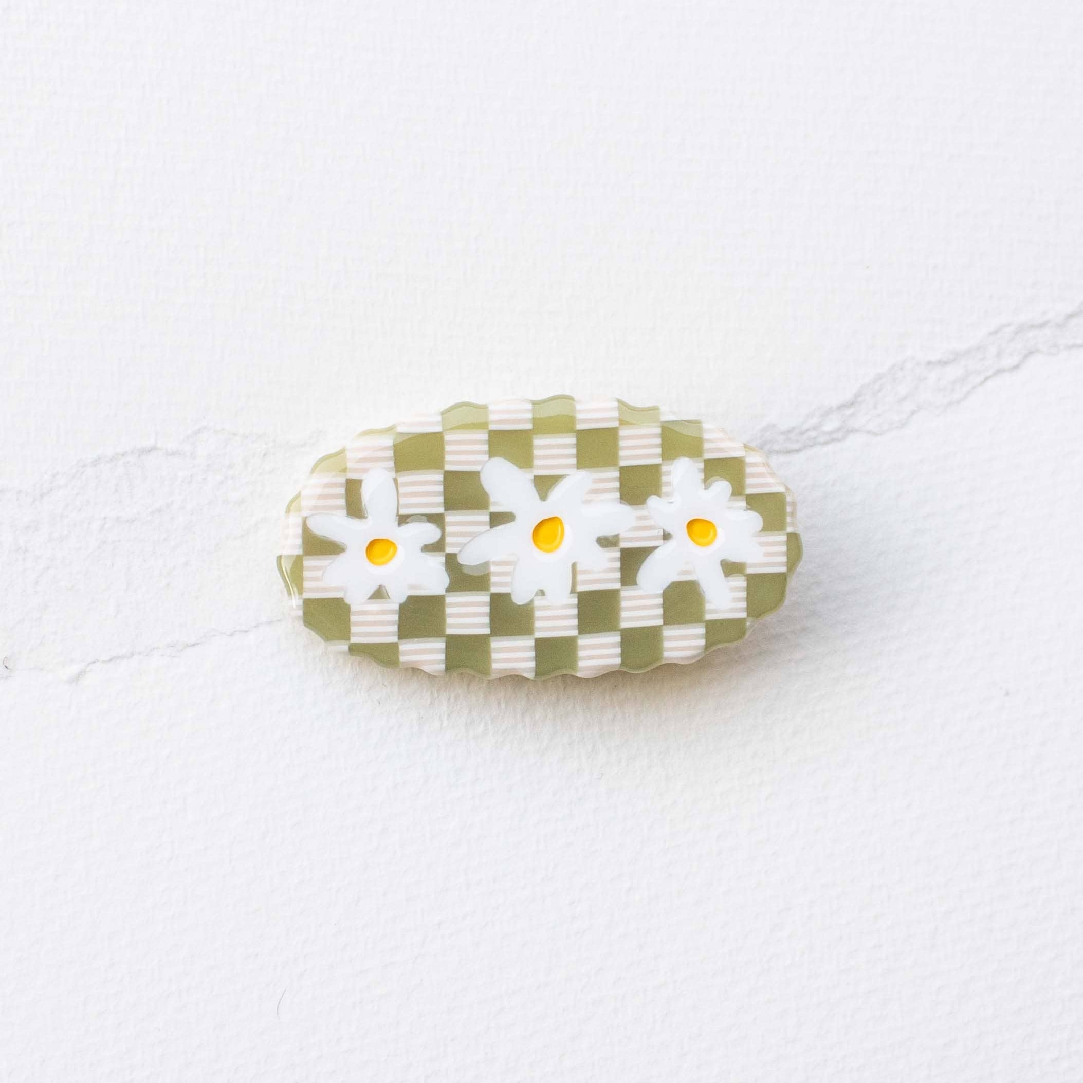 Brighten your day with these charming lime-colored hair pins featuring a cheerful daisy design. Crafted from eco-friendly acetate, they combine sustainable style with playful flair. The checkered pattern adds a vintage-inspired touch perfect for securing your hair while making a statement. Whether you're dressing up for a special occasion or adding personality to your everyday look, these pins offer both function and fashion. A delightful accessory that celebrates your commitment to eco-conscious choices.