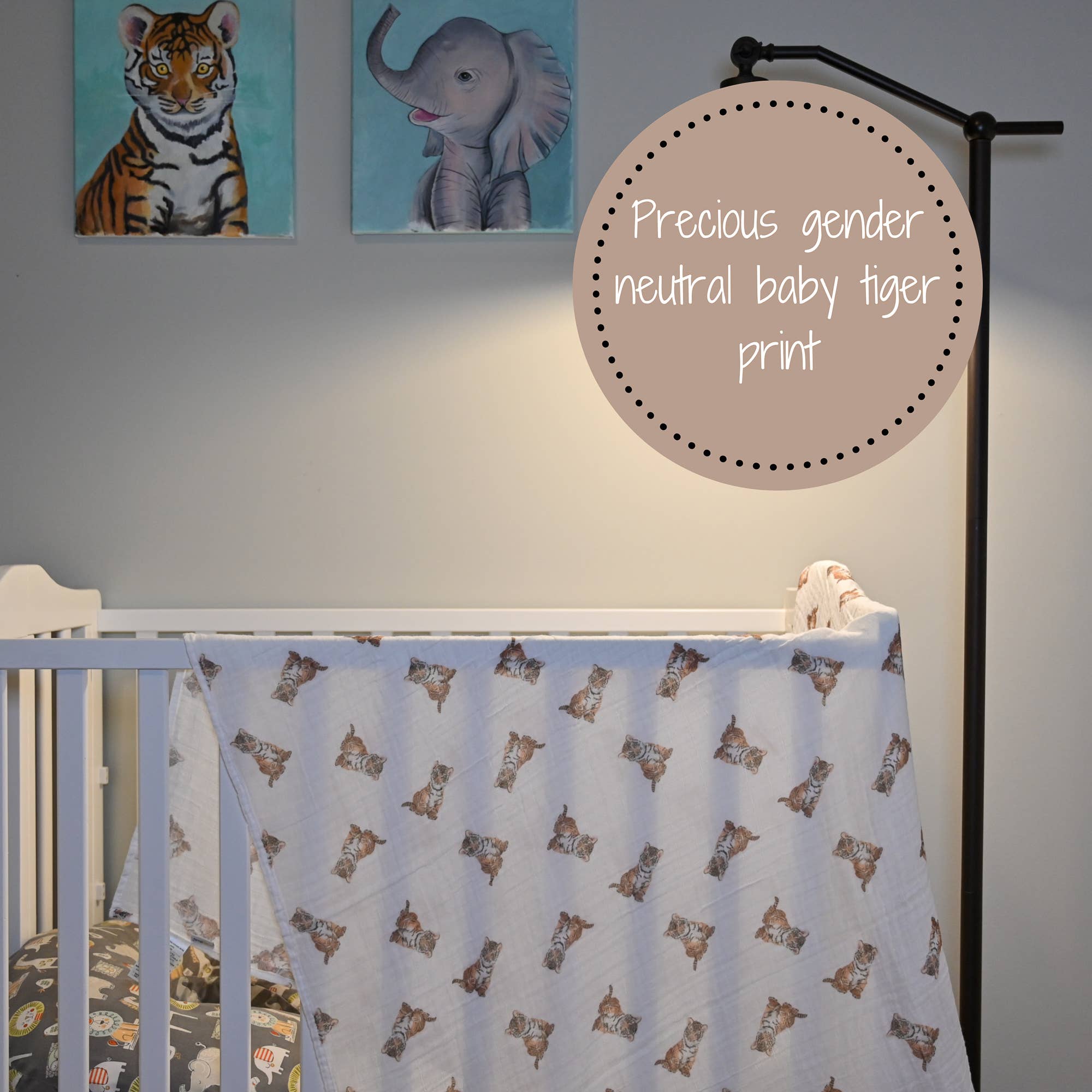 Crib with tiger print crib sheet, wall art of a tiger and an elephant, and text indicating 'Precious gender neutral baby tiger print'.