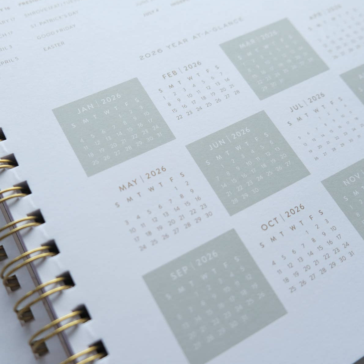 Close-up of a spiral-bound planner with calendar pages.