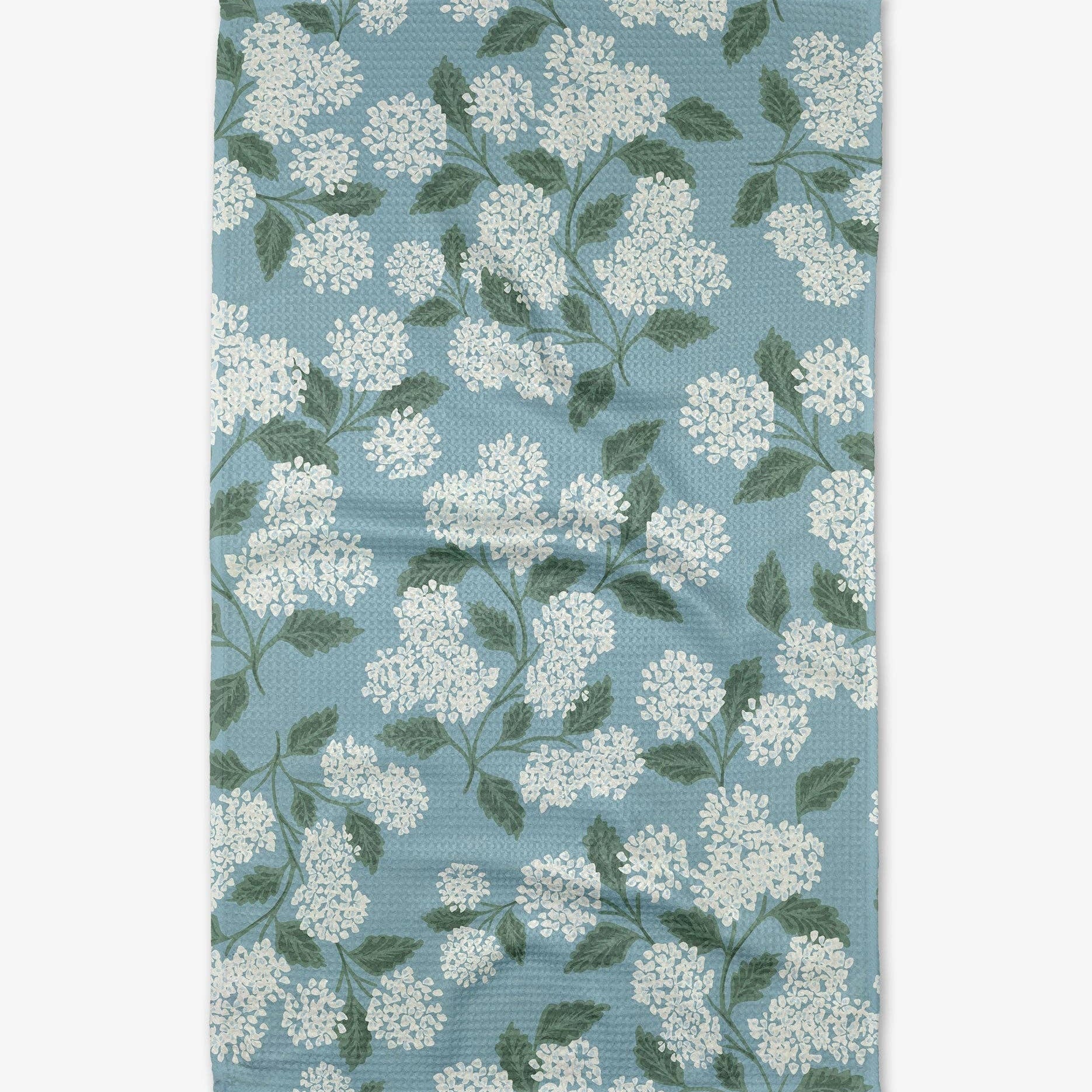 Floral patterned fabric with white flowers and green leaves on a blue background
