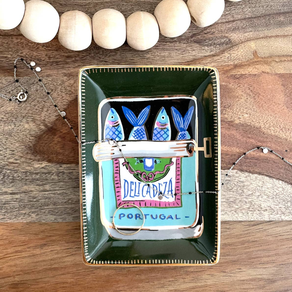 A fan favorite giftable–Our ceramic trinket dishes are the perfect catchall for your nightstand or dresser. White ceramic is adorned with our colorful, hand-painted designs, and we lined the edge in 10k gold for added flair. Perfectly packaged in plastic-free gift boxes, pretty enough to give without wrapping!

• 3″ x 3″ Dish

• Ceramic with 10k Gold Detailing

• Plastic-Free Gift Box
