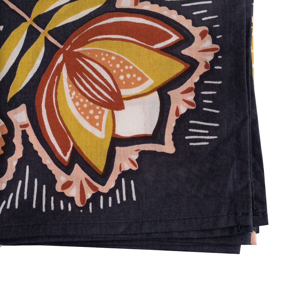 Folded fabric with a colorful leaf pattern on a black background