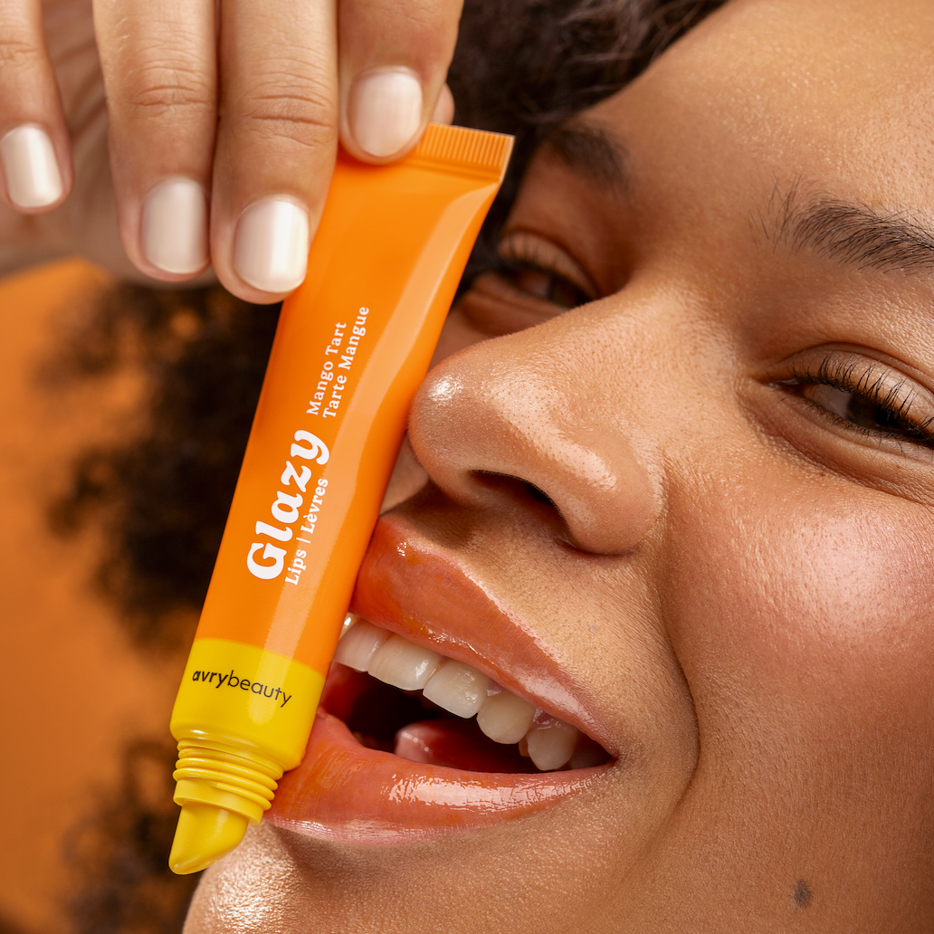 Person holding an orange Glazy product near their face
