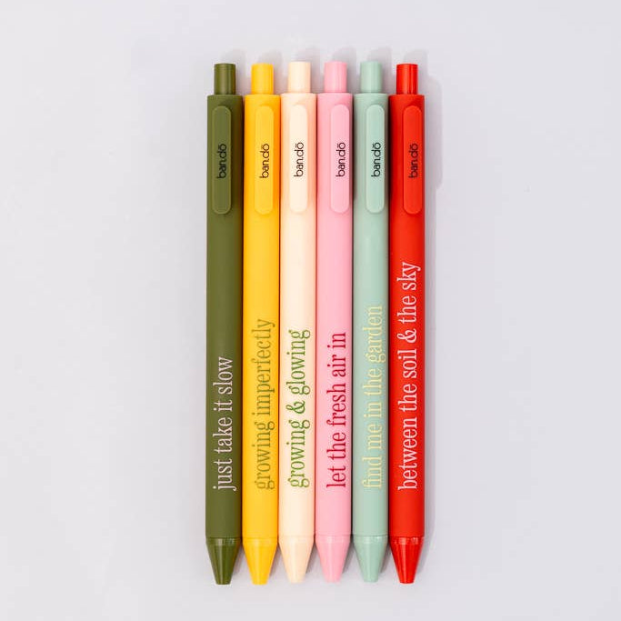 Set of colorful pens with motivational text on a light gray background